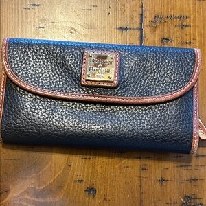 Dooney & Bourke Black Pebbled Leather Wallet with Brown Trim and Brass Plaque